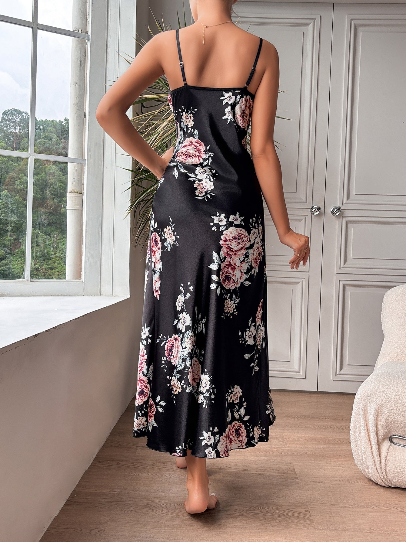 Black floral slit camisole dress displayed